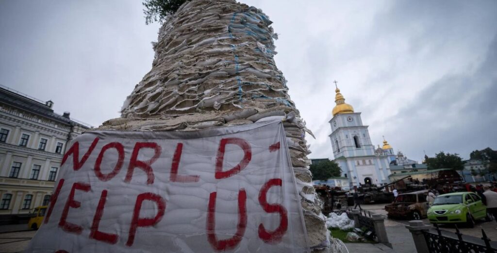 A sign reading “World, help us” is hung near St. Michael’s Golden-Domed Monastery in Kyiv. Photo/LWF/Albin Hillert