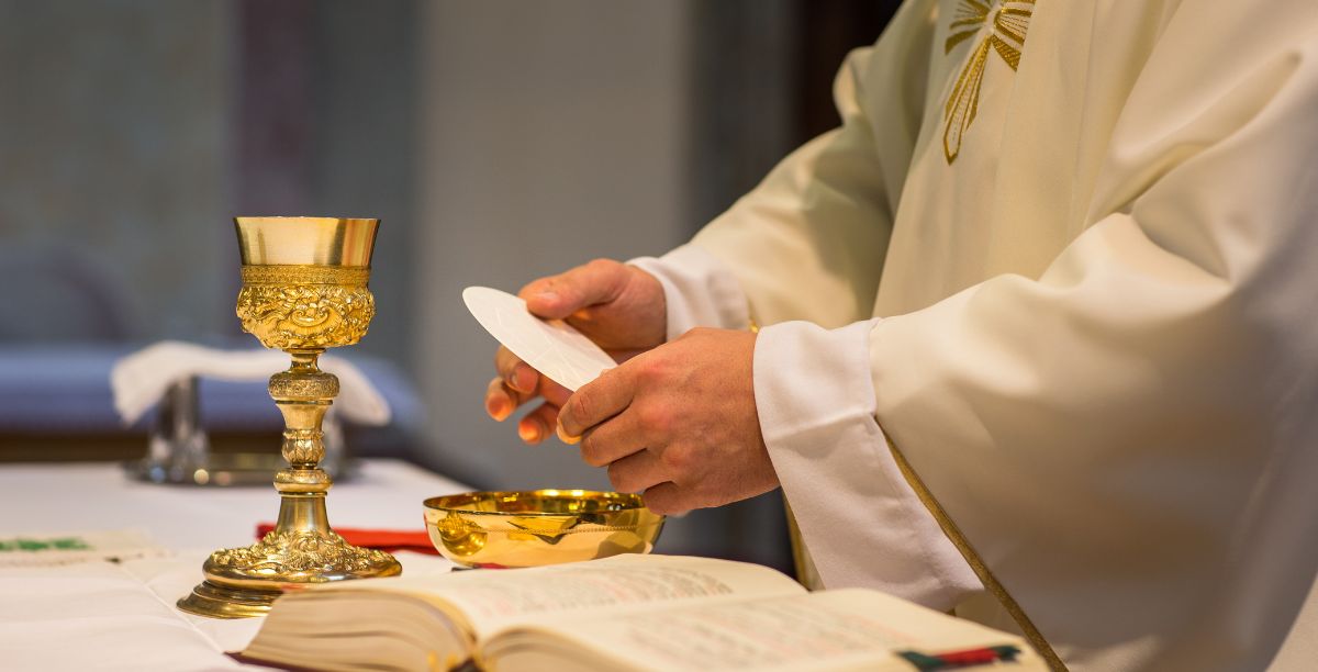 Padre prepara comunhão. Foto Viktor Cap