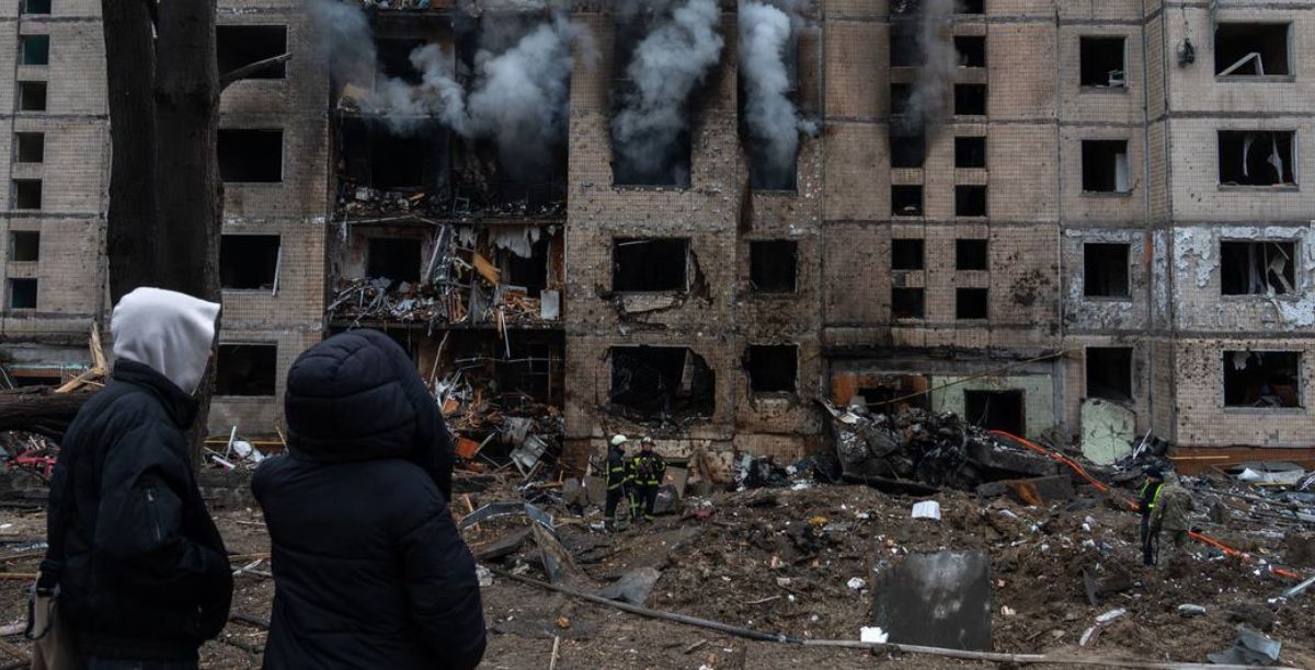 Pessoas observam edifício em chamas, após um bombardeamento. na Ucrânia Foto © UNICEFAleksey Filippov