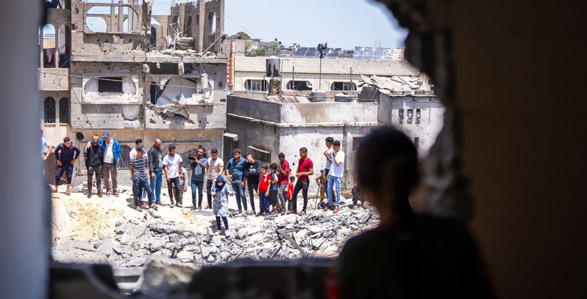 WHO Local people look at damage to a residential community in Gaza.