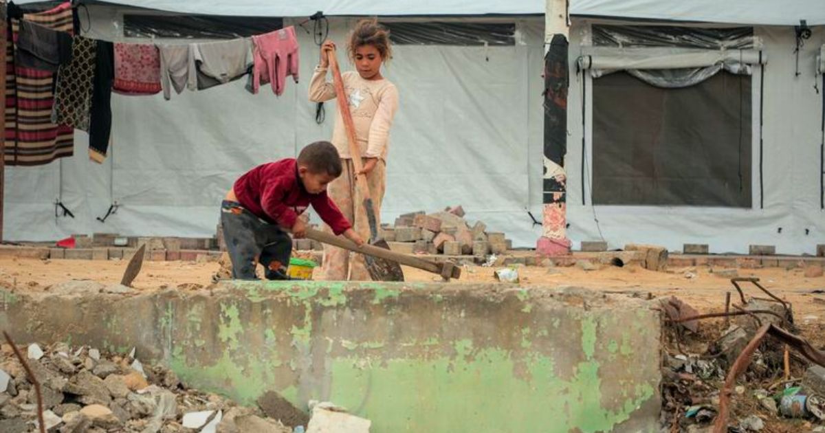 © UnicefMohammed Nateel Duas crianças limpam os destroços do lado de fora de uma tenda na cidade de Gaza © UnicefMohammed Nateel Duas crianças limpam os destroços do lado de fora de uma tenda na cidade de Gaza